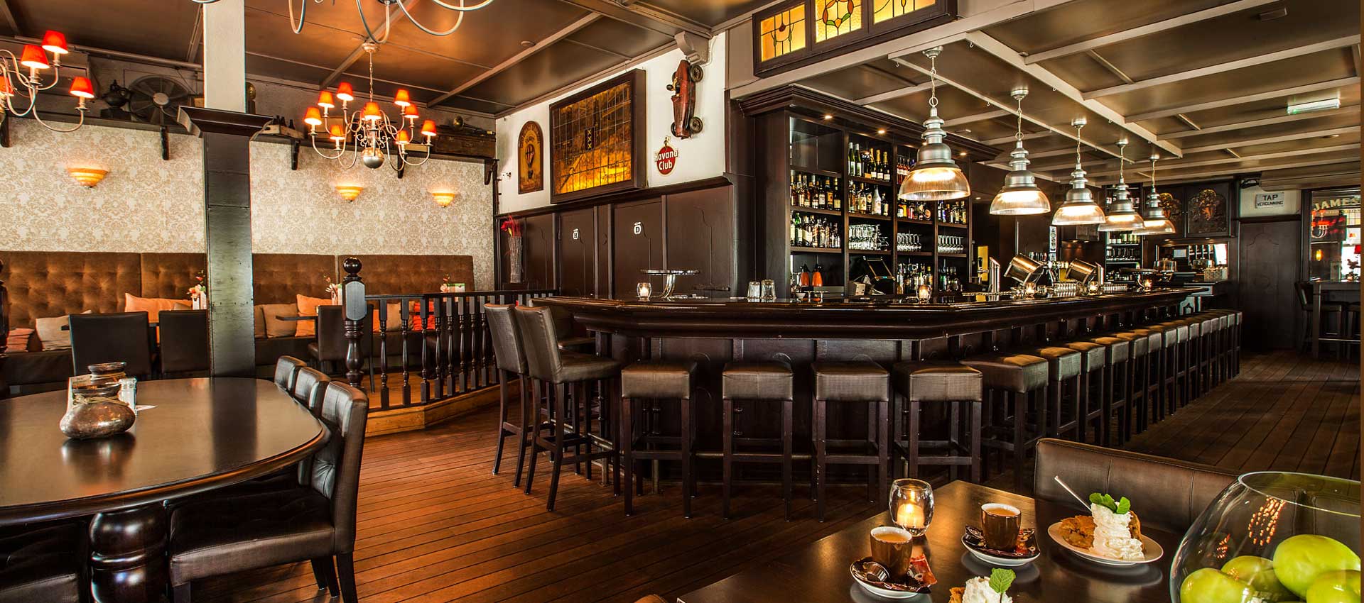 De houten bar en het warme interieur van De Appel in Hengelo